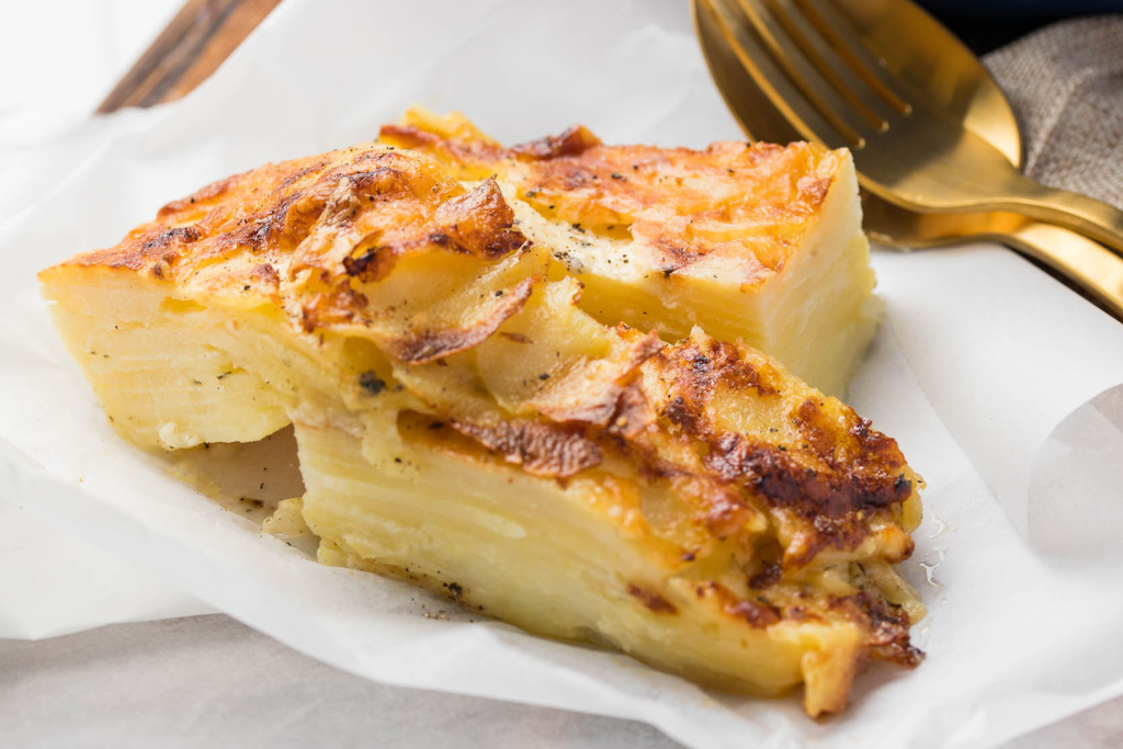 A tempting sight of our Potato Bake, ready to complement any meal with its creamy goodness, serving 4-6