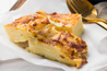 A tempting sight of our Potato Bake, ready to complement any meal with its creamy goodness, serving 4-6
