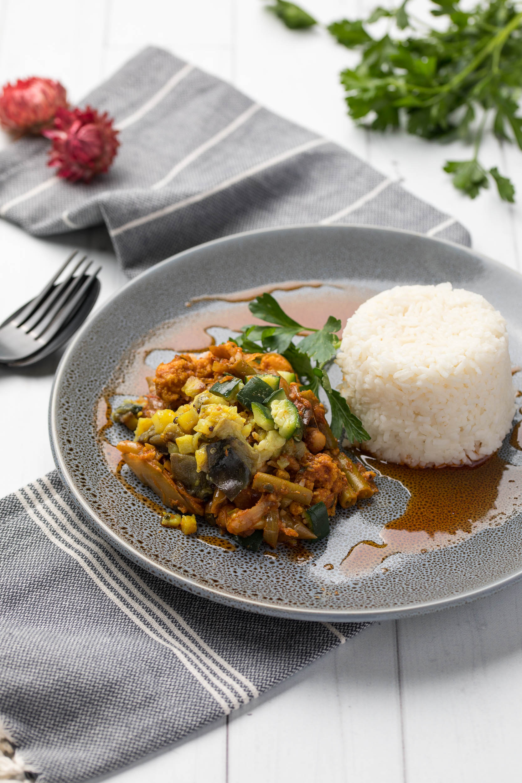 Experience the vibrant flavors of our Seasonal Vegetable Curry & Rice, packed with fresh veggies and traditional Indian spices, a delicious solo meal.